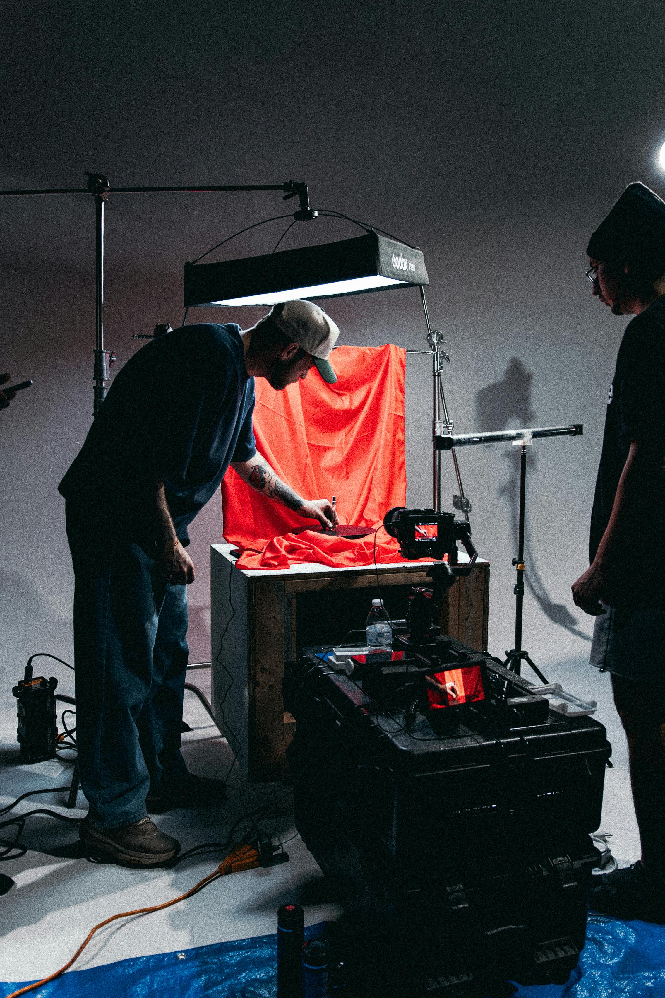 Videographer filming in a professional studio setup